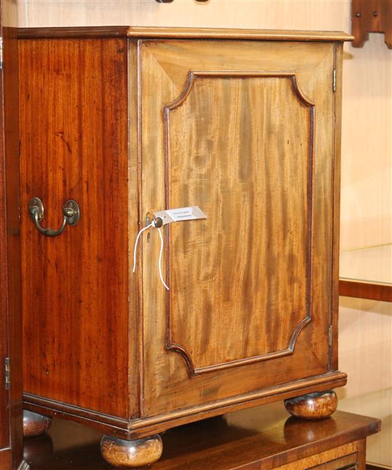 A Victorian mahogany cupboard, enclosed by a panelled door W.50cm